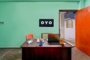 an office with a desk with a laptop on it at Hotel O White Inn in Chennai