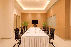 a conference room with a long table and chairs at Keys Select By Lemon Tree Hotels, Vadodara in Vadodara