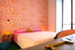 a bedroom with a bed and a colorful wall at BAD - B&B And Design in Catania