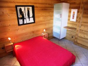 a bedroom with a red bed and a refrigerator at Résidence Marmottes Ii - 3 pièces 6 personnes MAE-2780 in Orcières