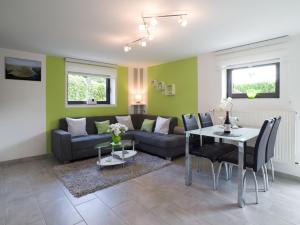 a living room with a couch and a table at Ferienwohnung Alexandra in Mettlach
