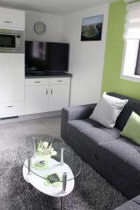 a living room with a couch and a coffee table at Ferienwohnung Alexandra in Mettlach