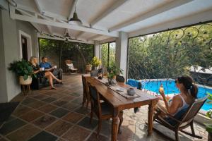 a woman sitting at a table on a patio at Haus Müller in Clanwilliam