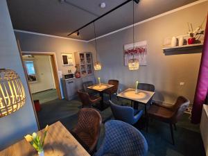 a dining room with two tables and chairs at Hotel Garni "Villa am Schaalsee" in Zarrentin