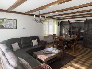 a living room with a couch and a table at Alpenblick am Kienberg in Pfronten