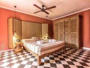 a bedroom with a bed with a ceiling fan at Cubanito Ibiza in San Antonio +40 photos