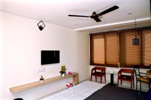 a bedroom with a bed and a flat screen tv at hotel cloud 20 in Jambusar