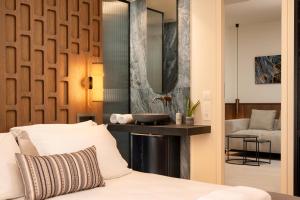a bedroom with a bed and a sink at Elounda Stories Boutique Hotel in Elounda