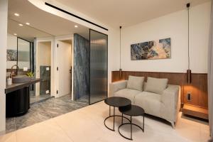 a living room with a couch and a table at Elounda Stories Boutique Hotel in Elounda