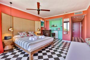 a bedroom with a large bed and a checkered floor at Cubanito Ibiza in San Antonio