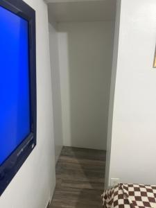 a flat screen tv hanging on a white wall at Downtown Taylor Room 5 in Phoenix