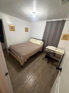 a small room with a bed and a desk and a desk at Downtown Taylor Room 5 in Phoenix