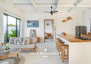 a kitchen and living room with a table and chairs at Villa Maracuya in Pecatu Bali - Spacious 3 Bedroom with Pool in Badung