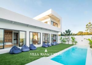 a bedroom villa with a swimming pool and a villa manager at Villa Maracuya in Pecatu Bali - Spacious 3 Bedroom with Pool in Badung +7 photos
