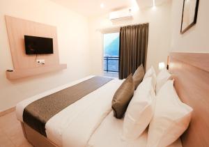 a bedroom with a large bed with a window at Alpine Retreat in Narendranagar