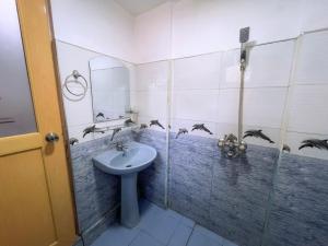a bathroom with a sink and birds on the wall at The Grand Residence in Ella +33 photos