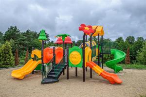 a playground with colorful slides and slidesktop at BELMAR Park Resort in Władysławowo