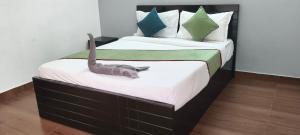 a bedroom with a bed with a dinosaur on it at Elevate 1478 Inn in Nandigunda