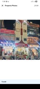 a picture of a building with traffic in front of it at Hotel Grand Inn in Haridwār