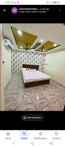 a picture of a bedroom with a bed in a room at Sheetal palce hotel in Ujjain +7 photos