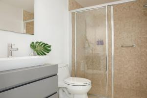 a bathroom with a shower with a toilet and a sink at Radisson Blu Aruba in Palm-Eagle Beach +195 photos