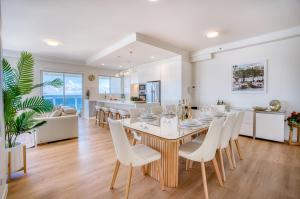 a dining room and kitchen with a table and chairs at Xanadu Resort in Gold Coast