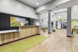 an office lobby with a reception desk and tables at Spark by Hilton Abingdon I-81 near Fairgrounds in Abingdon +63 photos