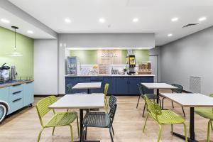 a cafeteria with tables and chairs and a counter at Spark by Hilton Abingdon I-81 near Fairgrounds in Abingdon