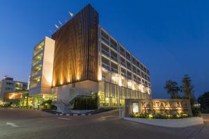 a large building with a lit up facade at night at Kantary 304 Hotel Prachinburi in Si Maha Phot +55 photos