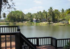 a view of a body of water with palm trees at Base 22 Hatyai in Ban Rai
