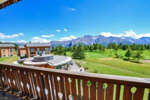 a balcony with a view of a resort and mountains at Hollandia 26 in Riederalp