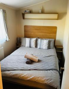a bed with a wooden headboard in a bedroom at Dixons Den Hot Tub in Swarland +15 photos