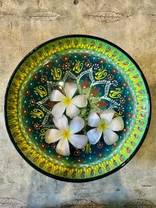 a plate with three white flowers on it at Wave-F in Ko Kood