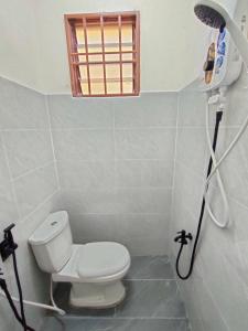 a bathroom with a toilet and a shower at Homestay Che Wan in Kuantan +14 photos