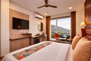 a hotel room with a bed and a television at AH Grand Villa - Hotel Near Dalai Lama Temple in McLeod Ganj +50 photos