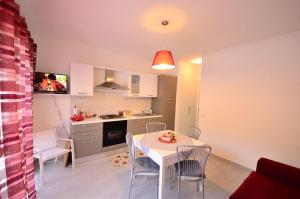 a kitchen and dining room with a table and chairs at Villa Giorgia in Cefalù