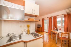 a kitchen with a sink and a counter top at Villa Albatros in Vinišće