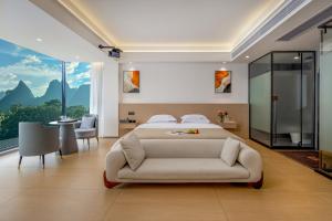 a bedroom with a large bed and a couch at Jiheshan residential accommodation Yulong River Yangshuo in Yangshuo