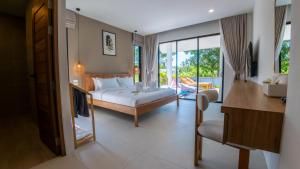 a bedroom with a bed and a desk in a room at FarmSaijai Kohphangan in Hinkong +64 photos