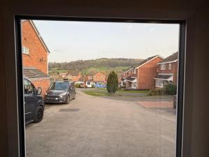 a view of a residential street with cars parked at The Escape in Wirksworth