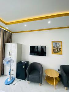 a living room with two chairs and a table at Hotel 24h in Hai Phong