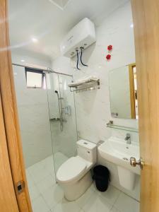a bathroom with a toilet and a sink at Hotel 24h in Hai Phong