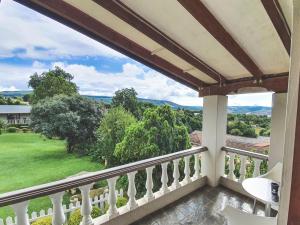 a balcony with a view of a green yard at Sunrise Guesthouse in Greytown