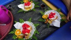 a table topped with different types of food on paper at Sumatra Orangutan Tours Orangutan Trekking with Airport Pick Up Drop Off and Accommodation Trekking Required for All Bookings in Bukit Lawang