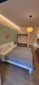 a bedroom with a large white bed in a room at Amelia's Garden ΙΙ in Kavos +50 photos