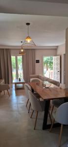 a dining room and living room with a table and chairs at Amelia's Garden ΙΙ in Kavos