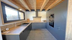 a large kitchen with a sink and a window at Chalet - Superbe Chalet 12 pers MAE-2644 in Les Prés