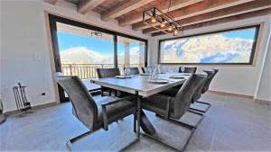 a dining room with a table and chairs with a view at Chalet - Superbe Chalet 12 pers MAE-2644 in Les Prés
