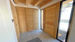 a hallway with wooden doors in a house at Chalet - Superbe Chalet 12 pers MAE-2644 in Les Prés +20 photos