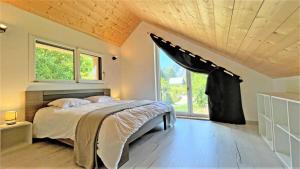 a bedroom with a bed and a large window at Chalet - Magnifique chalet d'architecte 10 pers MAE-2774 in Les Prés
